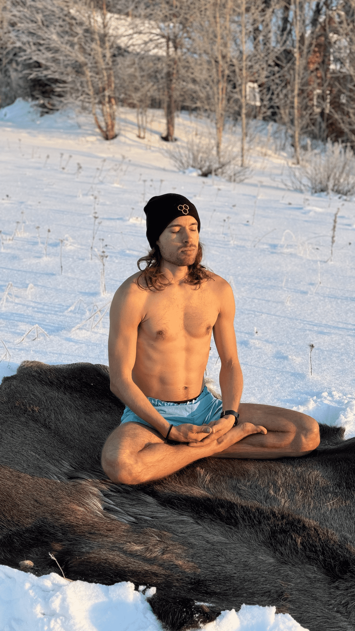 Filip Krzyzanowski meditating outdoors in a snowy landscape